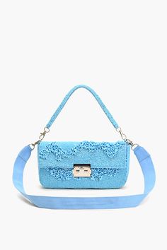 Embellished Design: Fully adorned and embroidered. Dual Handles: Top beaded handle and detachable shoulder strap. Secure Closure: Padlock mini clasp. Functional Interior: Lined with a zip pocket. Dimensions: 10" x 5" x 2"; Belt: 40" x 1.25" Make a statement in style with our latest masterpiece: the Azure Blue Skyline Shoulder Bag. Elevate your ensemble effortlessly with this stylish accessory, marrying practicality with panache. Crafted with meticulous attention to detail and fashioned from prem Evening Light Blue Shoulder Bag With Detachable Strap, Blue Shoulder Bag With Adjustable Strap For Party, Light Blue Evening Bag With Detachable Strap, Blue Evening Shoulder Bag With Detachable Strap, Blue Shoulder Evening Bag With Detachable Strap, Summer Embellished Rectangular Shoulder Bag, Blue Beaded Shoulder Bag As Fashion Accessory, Blue Beaded Clutch Bag, Blue Rectangular Embellished Shoulder Bag