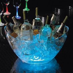 a glass bowl filled with lots of bottles