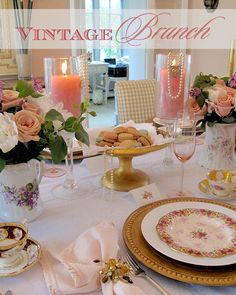 the table is set with pink and white plates, silverware, and pineapples