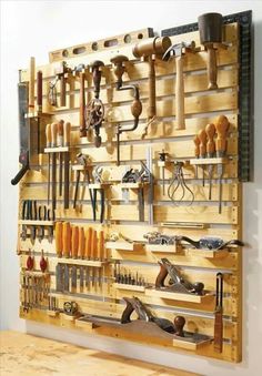 a wall mounted tool rack filled with lots of tools on it's sides and shelves