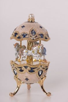 an ornately decorated trinket with blue and white decorations on it's sides