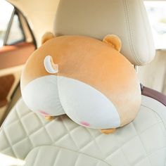 a stuffed animal sitting in the back seat of a car with it's eyes closed