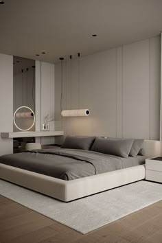 a large bed sitting in the middle of a bedroom next to a wall mounted mirror