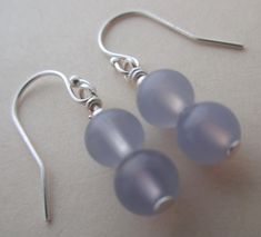 Lavender drop earrings, lavender and silver earrings, chalcedony earrings lavender chalcedony sterling silver earrings, handmade * The round chalcedony drops are 1/4 inch wide and long. * From the top of the earrings, the lavender sterling silver earrings are just over one inch long. Sterling Silver Earrings Handmade, Lavender Earrings, Chalcedony Earrings, Silver Earrings Handmade, Sterling Silver Drop Earrings, One Inch, Silver Drop Earrings, Hand Made Jewelry, Honolulu