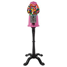 a pink and black gummy machine with lots of balls on it's stand