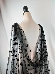 a black and white scarf on a mannequin's torso with stars all over it