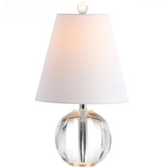 a glass lamp with a white shade on it