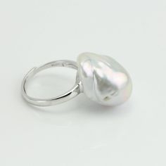 The ring is made of large size freshwater baroque pearls with 13-15mm large size white baroque pearl what' most important , it is so affordable price, Item No: RIN200 Item:genuine freshwater pearl ring Pearl shape:baroque pearl Pearl size:around 13-15mm wide Pearl color: white Pearl skin:clean, Pearl luster: good Pearl quality: AA Metal: sterling silver Ring size:suitable fingure size from US5.5 to US9, open ring, size adjustable Packing: beautiful gift box,ready for gift giving Please contact L Elegant Silver Rings With Baroque Pearl, Elegant Silver Baroque Pearl Rings, Baroque Pearl Ring With Pearl Drop For Weddings, Baroque Pearl Drop Ring As Gift, Wedding Pearl Drop Ring With Baroque Pearl, Baroque Pearl Ring For Anniversary, Wedding Baroque Pearl Ring With Pearl Drop, White Baroque Pearl Ring For Gift, White Baroque Pearl Rings For Anniversary