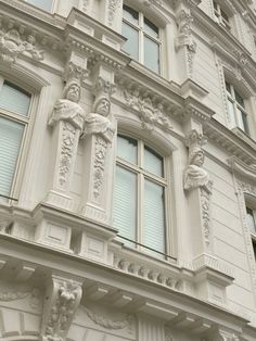 an ornate building with many windows and statues on it