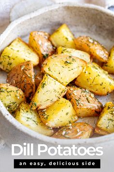 a white bowl filled with potatoes on top of a table