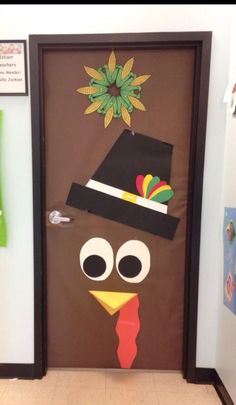 a door decorated to look like a turkey with a top hat on it's head