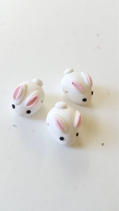 three small white ceramic animals sitting on top of a table