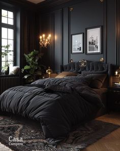 a bedroom with dark walls and black bedding