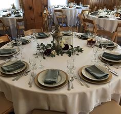 the table is set with silverware and place settings