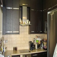 a kitchen with brown cabinets and silver appliances