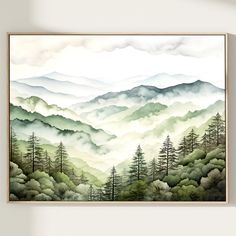 a painting hanging on the wall above a bed in front of a white wall with mountains and trees