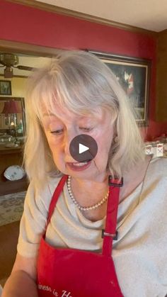 an older woman is making funny faces in the kitchen