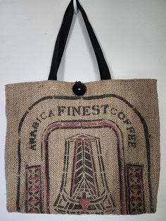 One-of-a-kind tote bag made from a burlap coffee bean sack from a local Colorado Springs coffee roaster. The bag is fully lined and interfaced with a 9"x 9" zippered pocket to protect your keys and cell phone. Perfect for the beach, picnics, sporting events or shopping. Dimensions:  19" wide x 15" tall Natural burlap with black burlap accent Lined with black cotton fabric Zippered pocket, 9"x 9"  Exterior pocket on the back, 6" x 8" Black webbing straps with 10" handle drop Button closure The bu Burlap Coffee Bags, Coffee Roaster