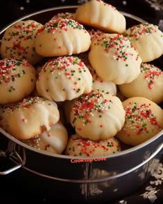 a pan filled with cookies covered in sprinkles on top of a table