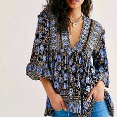 Embrace Your Inner Goddess In This Strikingly Beautiful Tunic From Free People, In An Exquisite Batik Floral Print Full Of Rich Blues, Camel Brown, Ivory & Black. Gorgeous As A Sexy Mini Dress Or Tunic Top Worn With Jeans. Full Of Intricate Details, It Features A Loose Flowy Silhouette, Deep V-Neckline With Self-Tie Closure, Crochet Inset, Drop Shoulders With Ruffle Details, Flared Sleeves With Wide Ruffles, Side Pockets & High-Low Hemline. 100% Viscose. Generously Sized. Approx. Bust 21”, Lengt Black Bohemian Printed Blouse, Black Bohemian Top With Boho Print, Black Bohemian Blouse With Floral Print, Black Bohemian Tops With Boho Print, Black Floral Print Festival Blouse, Black Floral Print Blouse For Festival, Boho Tunic Tops, Printed Tunic Tops, Waffle Knit Top