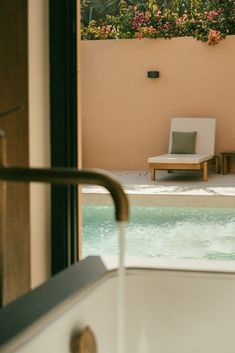 a white chair sitting next to a swimming pool