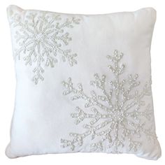 a white pillow with snowflakes on it