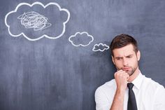 a man is thinking about something with thought bubbles above his head on a chalkboard