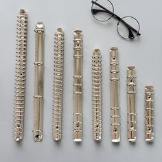 an assortment of silver items including glasses and combs