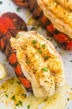 some chicken and vegetables are on a white plate with seasoning sprinkles