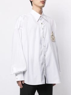 This Dolce & Gabbana Cotton Formal Shirt features a classic neckline, long sleeves, and a button-down closure. Made in Italy, it is a Regular fit and is made of 100% Cotton. The front button closure and logo details add stylish elements to this white shirt. Long sleeves Button down closure Regular fit 100% Cotton White Front button closure Logo Details Made in Italy Luxury Long Sleeve Shirt With Button Closure, Luxury Long Sleeve Shirt, Designer Long Sleeve Shirt With Button Closure, Luxury Cotton Long Sleeve Blouse, Luxury Long Sleeve Cotton Blouse, Designer Collared Blouse With Button Closure, Designer Button-up Shirt With Button Closure, Designer Long Sleeve Tops With Button Cuffs, Designer Blouse With Collar And Button Closure