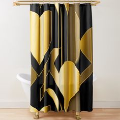 a black and gold shower curtain with heart shapes on the bottom, in front of a white bath tub