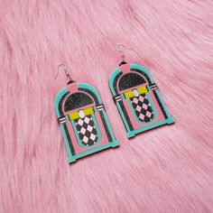 These rad af Jukebox Earrings are super colorful, and are an awesome statement piece for any outfit! They were designed digitally by BC, then laser cut with many colors of 1/8 of an inch thick acrylic. The pendants were attached to a lightweight layer of 1/16" black acrylic for extra durability while remaining lightweight.Each pendant was then added securely to a silver hypoallergenic earring hook.From top of earring post to bottom of pendant- 3.25 inches tall.These earrings can be made as hooks Retro Pink Earrings For Party, Retro Pink Party Earrings, Retro Rectangular Earrings For Gift, Retro Dangle Earrings, Retro Dangle Earrings Gift, Retro Dangle Earrings For Gift, Retro Pink Drop Earrings, Funky Pink Earrings For Gift, Retro Multicolor Earrings With Ear Wire