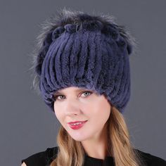 a woman wearing a blue hat with fur on it