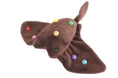 a brown stuffed animal with multicolored dots on it's ears