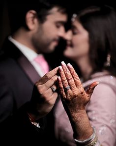 a man and woman are holding their hands together