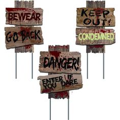 four wooden signs that say go back, danger, and enter if you dare to be out