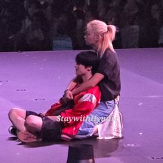 two people sitting on top of each other