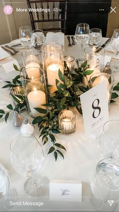 the table is set with candles and place cards