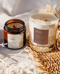 a candle sitting on top of a bed next to a jar