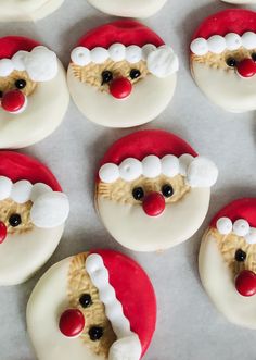 twelve decorated cookies with santa claus's face on them