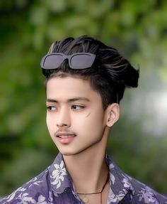 a man with sunglasses on top of his head wearing a purple shirt and flowered shirt