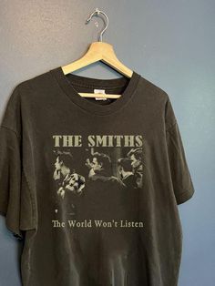 Vintage The Smiths Aesthetic Inpsired Tee, The Smiths - The World Won't Listen Shirt ** ITEM DESCRIPTION 5.3-ounce, 100% cotton Double-needle neck, sleeves and hem Decoration type: Digital Print Made by Gildan ** PLEASE NOTE: Due to lighting effect and computer color, the actual color may be slightly different from the picture, please understand. Please allow 0.3-0.5" / 1-2 cm differs due to manual measurement. ** For any other COLORS, SIZES, DESIGNS, please message us. ** OUR PRODUCTS: are made in & shipped from UNITED STATES, shipping to US and CANADA area will be faster. If you want to buy shirts in BULK, pls contact us. If you are not satisfied with our products and services, please do not leave negative or neutral feedback before giving us an opportunity to resolve the problem first. The Smiths Tshirt Print, Cheap Vintage Shirt With Relaxed Fit, Smiths Aesthetic, The Smiths Aesthetic, The Smiths Shirt, The Smiths, Aesthetic T Shirts, 80s Retro, Retro Shirts