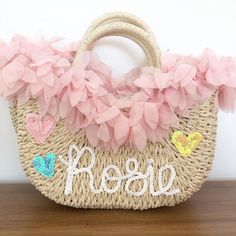 Price is inclusive of your chosen finish, flowers, lace, pom-poms, petals and personalisation.The round handled straw bags are available in baby pink, baby blue, soft tangerine, lemon, black, dark and natural straw. Hessian/jute bags available in many colours, please contact me for details.The straw bags (picture example Penny) are available in natural straw only.Please leave personalisation details of finish and name in the notes box at checkout.Follow me on Instagram to see new ideas and exclu Pink Spring Straw Bag With Braided Handles, Pink Straw Bag With Braided Handles For Spring, Spring Pink Straw Bag With Braided Handles, Pink Crochet Bag For Beach In Spring, Pink Crochet Beach Bag For Spring, Pink Handmade Straw Bag For Beach Season, Handmade Pink Straw Bag For Beach Season, Pink Bucket Beach Bag For Spring, Personalized Tote Bag For Summer