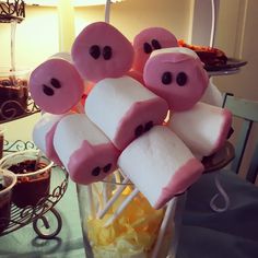 marshmallows with faces on them are arranged in a glass vase and placed on a table