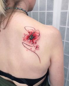 a woman with a flower tattoo on her back