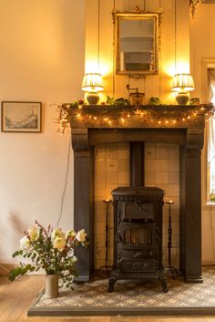 an old fashioned fireplace with lights on it