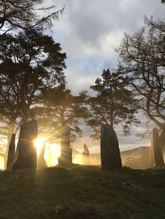 the sun shines through the trees at stonehenge