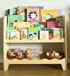 a wooden shelf filled with lots of children's books