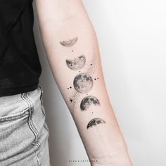 a woman's arm with three phases of the moon tattoo on it