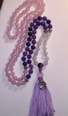 "Zen 108 Bead Mala. Silver spacer beads marked at 7-14-66. Silver marker beads with Amethyst guru bead, tassel and Om charm. Mala or Buddhist prayer beads, are a traditional tool used to count the number of times a mantra or the name or names of a deity is recited while meditating. The mala is used so that one can focus on the meaning or sound of the mantra rather than counting its repetitions. They are similar to other forms of prayer beads used in various world religions.  They are usually mad Bohemian Amethyst Beaded Necklaces With Round Beads, Spiritual Lavender Beaded Bracelets With 8mm Beads, Holistic Purple Round Beaded Jewelry, Spiritual Purple Beaded Bracelets For Meditation, Spiritual Purple Spacer Beads, Purple Round Beads Bracelet For Meditation, Purple Round Beaded Bracelets For Meditation, Purple Beaded Bracelets For Meditation, Spiritual Purple Gemstone Beaded Necklaces